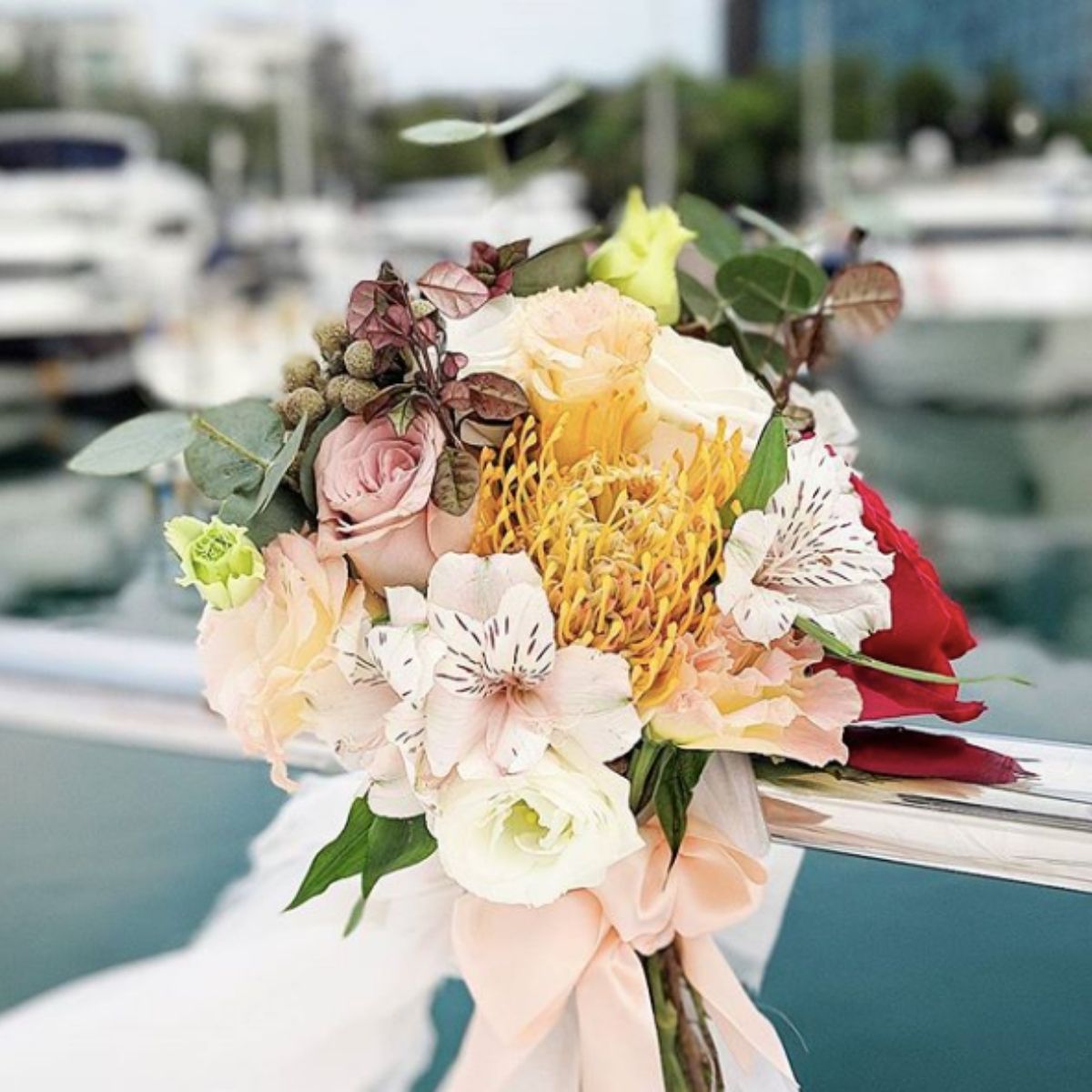 Pew ties pincushion protea tropical blooms ceremony aisle Singapore